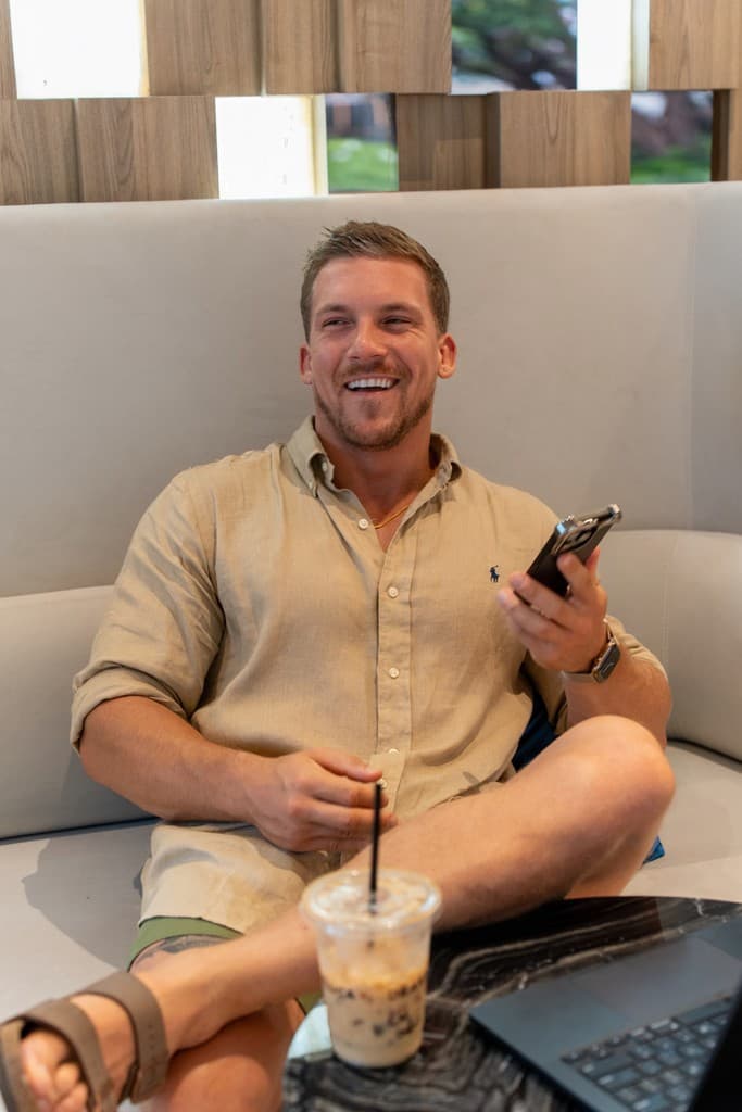 Wilcot laughing during a conversation, with his laptop nearby